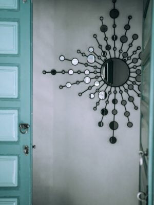 Decorative mirror on wall near door at home
