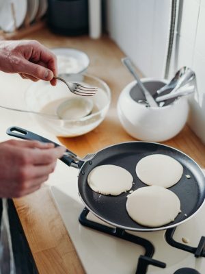 Person Cooking Pancake on Black Frying Pan