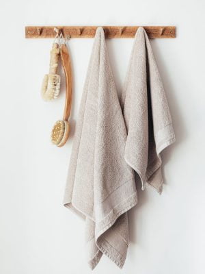 Wooden hanger with towels and body brushes